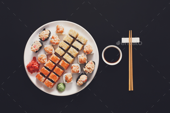 Set of sushi maki and rolls at black background - Stock Photo - Images