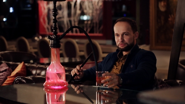 Young Intelligent Man Smoking Hookah alt