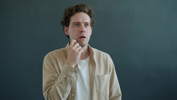 Portrait of Creative Guy Finding Solution Having Idea Smiling Raising Finger Standing on Gray alt