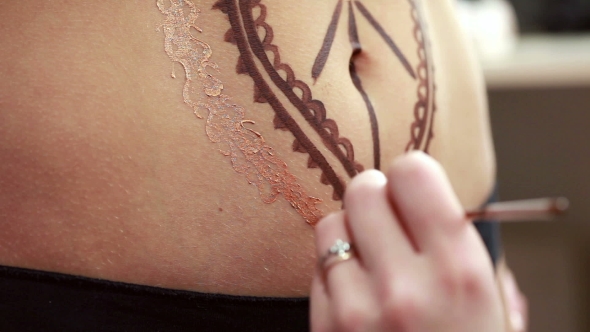 Mehndi. Master Draws On Girl's Stomach Using Henna