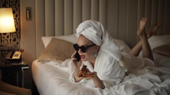 Fashion Woman Smiling Talking Using Smartphone After Shower Lying on Bed Full Shot