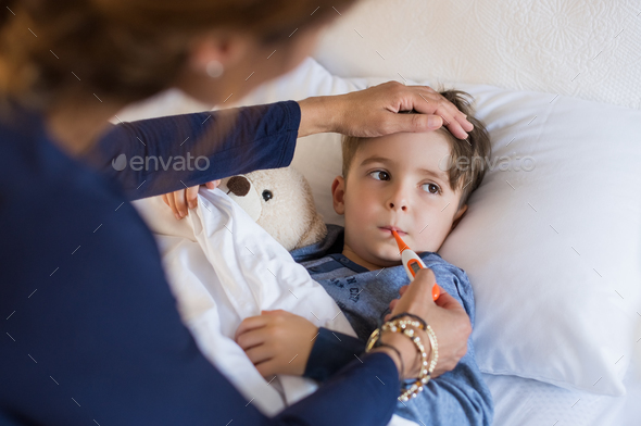 Boy measuring fever - Stock Photo - Images