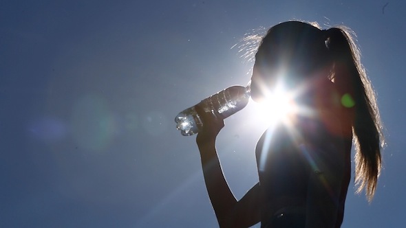 Girl Drinking Water With Flecks Of Sunlight