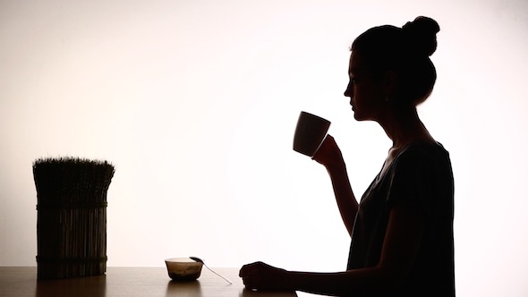 Silhouette Of Woman Drinking Tea