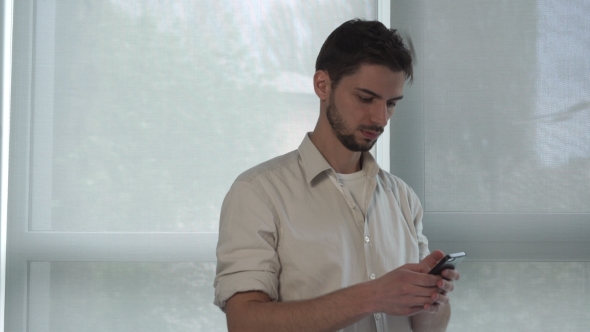 Man Texting Sms On The Mobile Phone alt