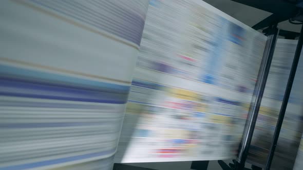 Colored Paper Moving on a Factory Conveyor, Close Up. alt