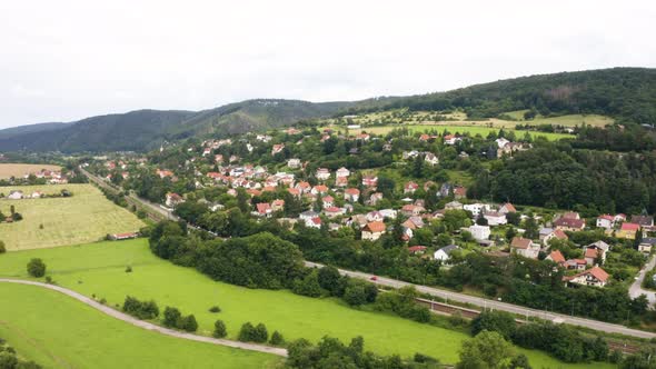 Aerial Drone Shot  a Picturesque Town in a Hilly Rural Area  Drone Flies in a Curve alt