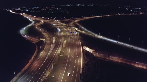 Aerial night shot of a bust highway with traffic in all lanes and street lights