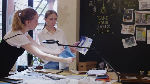 Female Designers Choosing Wallpaper for Interior Project in Studio