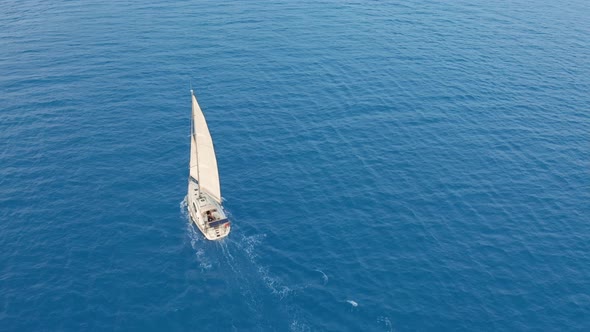Aerial View Yacht Sailing on Opened Sea. Sailing Boat Yacht From Above. Yachting at Windy Day