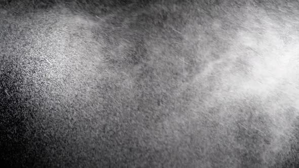 Water Spray on Black Background. Micro Drops of Water Fly in the Air. Slow Motion alt