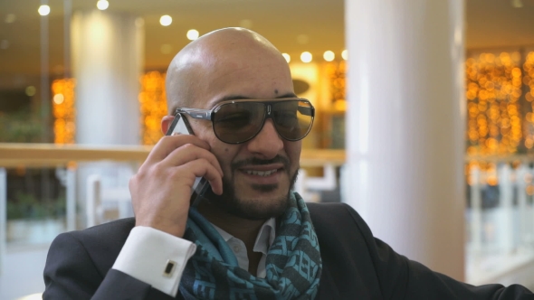 Arab Businessman Talking On Mobile Phone