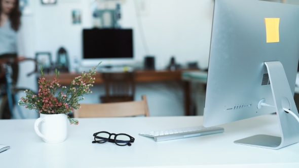 Woman Making Some Notes At Blueprints While Leaning To The Table In Office