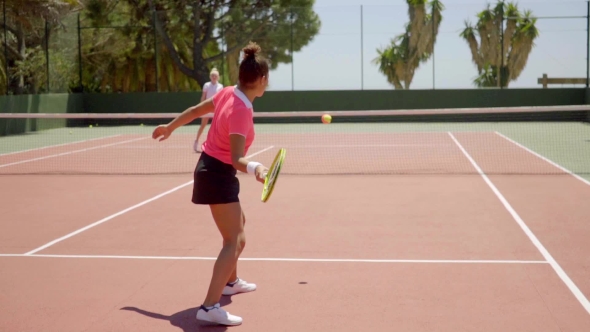 Two Woman Enjoying a Game Of Tennis alt