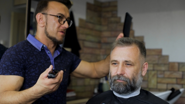 Cozy Barbershop, Is Engaged In a Professional Stylist Haircut Men Aged. alt