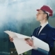 The Engineer In a Suit And a Helmet Studies Blueprints Indoors - VideoHive Item for Sale