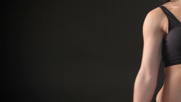 Fitness Woman Demonstrates Her Biceps alt