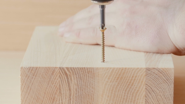 Screw Being Screwed Into a Piece Of Wood alt