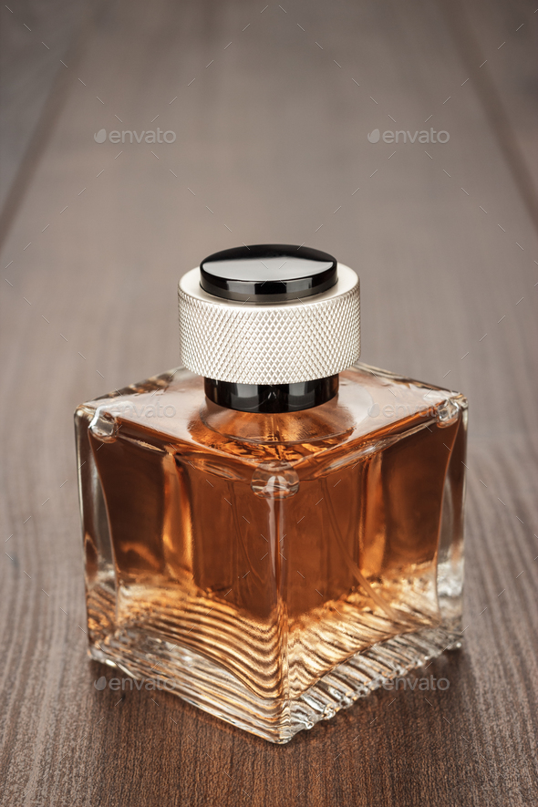 A bottle of perfume sitting on top of a table photo – Free Perfume