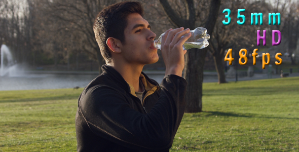 Healthy Young Man Drinking Water From the Bottle Outdoors 11