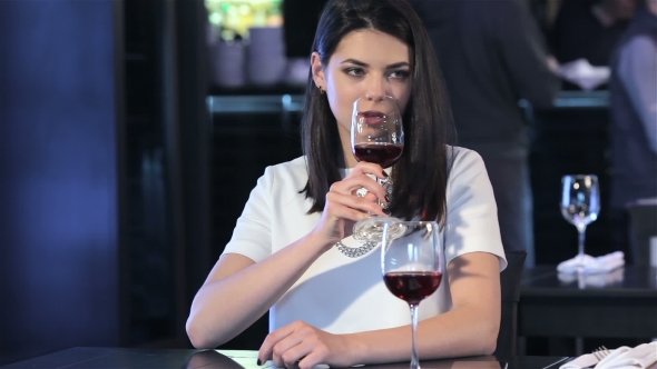 Girl Drinks Wine At The Restaurant alt