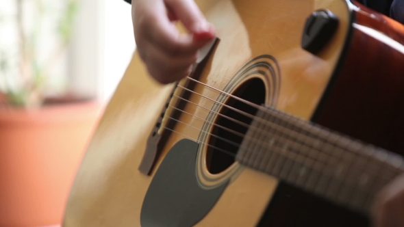 Little Boy Is Playing The Guitar 