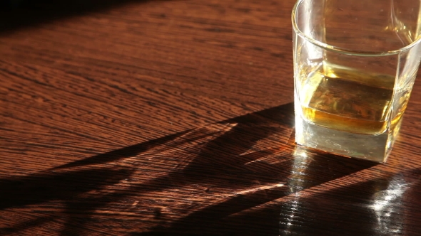 Whiskey Is On The Table - The Man's Hand Taking a Glass  