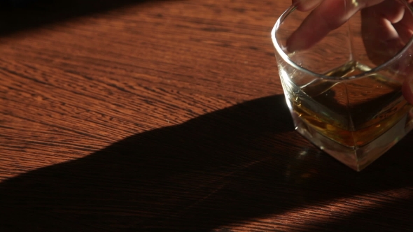 Whiskey Is On The Table - The Man's Hand Taking a Glass  