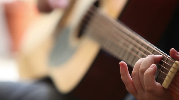 Little Boy Is Playing The Guitar 