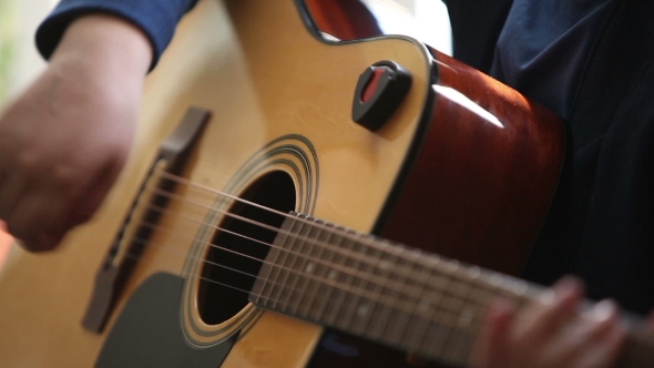 Little Boy Is Playing The Guitar 