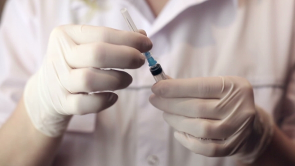 Woman Doctor Holding Syringe On Surgical Room 