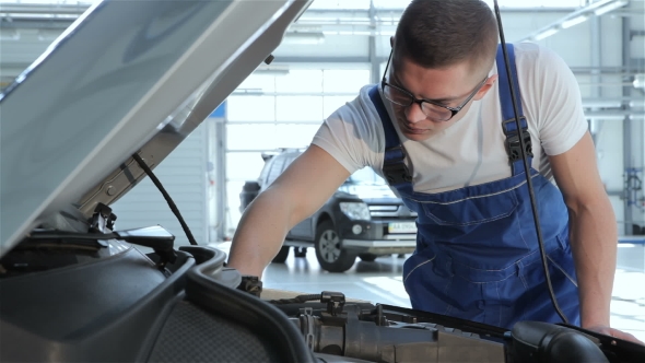 Mechanic Checks Up Serviceabillity Of The Car alt