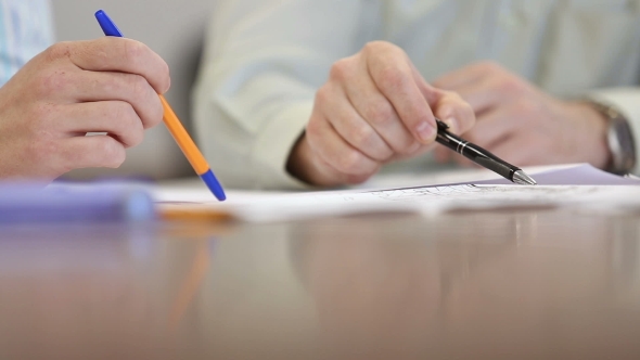 Male Hands Over a Desk To Show Drawing