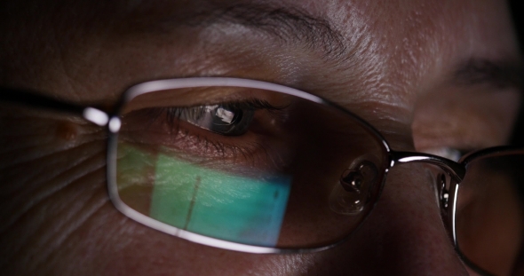 Senior Elderly Woman in Glasses Surfing Internet on Tablet Computer at Night alt