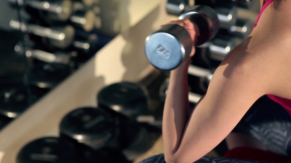 Woman Doing Exercise With Barbell In The Gym.