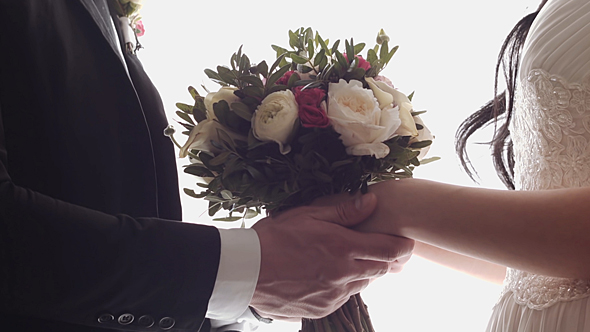 Couple Holding a Wedding Bouquet
