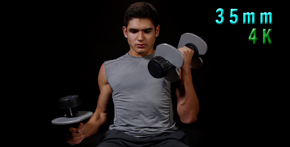 Young Man Working On Arms With Dumbbells 18
