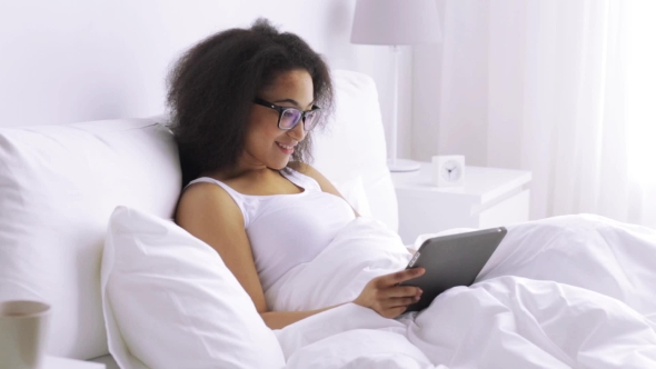 African Woman With Tablet Pc In Bed At Home 139 alt