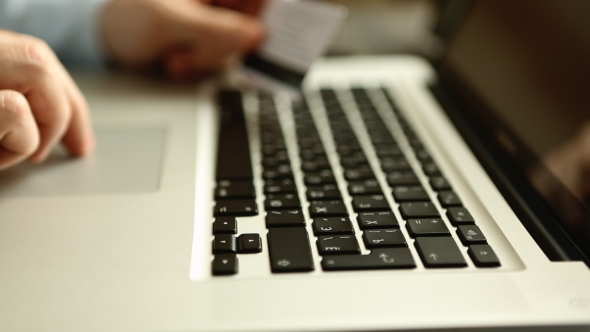 Male Hands With Credit Card During Shopping Through Internet