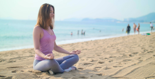 Woman Meditating on the Seashore