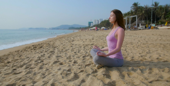 Woman Meditate  on the Beach in Slow Motion