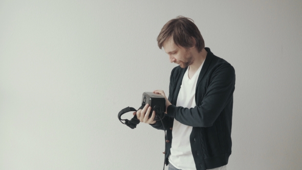 Man Wears The Virtual Reality Headset, Doing Movements And Looking Around alt