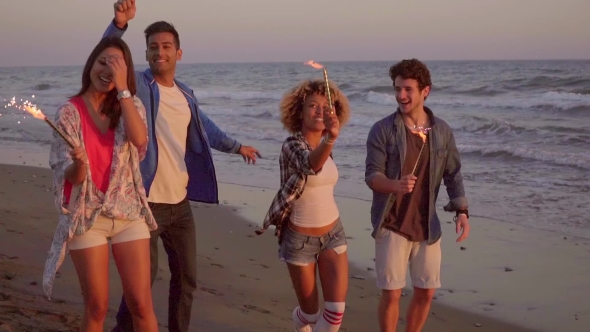 Young People With Fountain Candles On The Beach alt