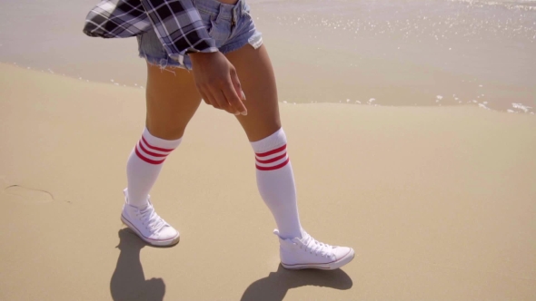 Young Sexy Woman Walking On The Beach. alt
