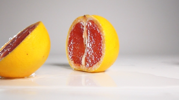 Grapefruit Break On Two Halves On White Surface alt