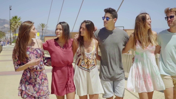 Group Of Trendy Young Friends Walking Arm In Arm alt
