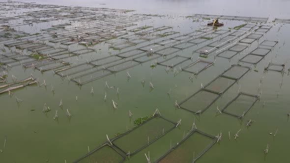 Aerial view of traditional floating fish pond on swamp in Indonesia alt