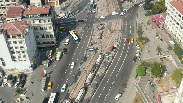 Tram Train Arriving in Public Transport Station in Istanbul, Aerial Tilt Up Revealing City Buildings alt