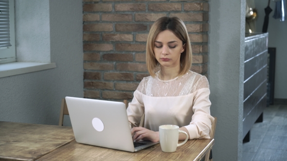 Young Woman Office Worker Typing On The Computer And Drinking Coffee alt