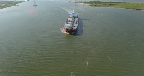 Aerial establishing shot of large tanker boat in water alt